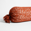 Allora Lace Throw Pillow | Autumn | A close-up of one end of an Allora Bolster Throw Pillow in Autumn, a rich terracotta tone, shown against a white background.