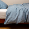 Austin Duvet Cover | Tahoe Blue | Midweight linen duvet cover in tahoe blue on a bed, side view.