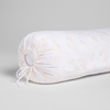 Lynette Throw Pillow | White | A close-up of the cinched end of the embroidered silk velvet bolster pillow shown against a white background.