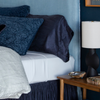 Paloma Pillowcase (Single) | deep dark blue charmeuse pillowcases styled with light blue sheets and duvet cover and reversible shams from the georgia collection.