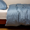 Bria Twin Duvet Cover | Tahoe Blue | duvet cover and matching sleeping pillow on white sheeting - side view.