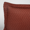 Cirillo Sham | Autumn | A close-up of the corner of a Cirillo Pillowcase in Autumn, a rich terracotta tone, shown against a white background.