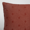 Ines Sham | Autumn | A close-up of the corner of an Ines Throw Pillow in Autumn, a rich terracotta tone, shown against a white background.