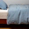 Linen Twin Duvet Cover | Tahoe Blue | duvet cover over white linen sheeting - side view.