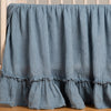 Linen Whisper Crib Skirt | Tahoe Blue | Linen crib skirt in tahoe blue on a wooden crib- side view.