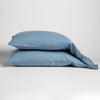 Linen Whisper Pillowcase (Single) | Tahoe Blue | Two sleeping pillows stacked at a slight angle against a plain background, showcasing ruffle trim detail - side view.