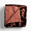 Lynette Blanket | Autumn | A close-up of the corner of a folded Lynette Bed End Blanket in Autumn, a rich terracotta tone, shown against a white background.