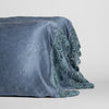 Paloma Pillowcase (Single) | Tahoe Blue | Tahoe Blue charmeuse with lace trimmed pillowcases standing upright against a white background.