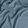 Madera Luxe Twin Flat Sheet | Tahoe Blue | a close up of tencel™ fabric gently rumpled.