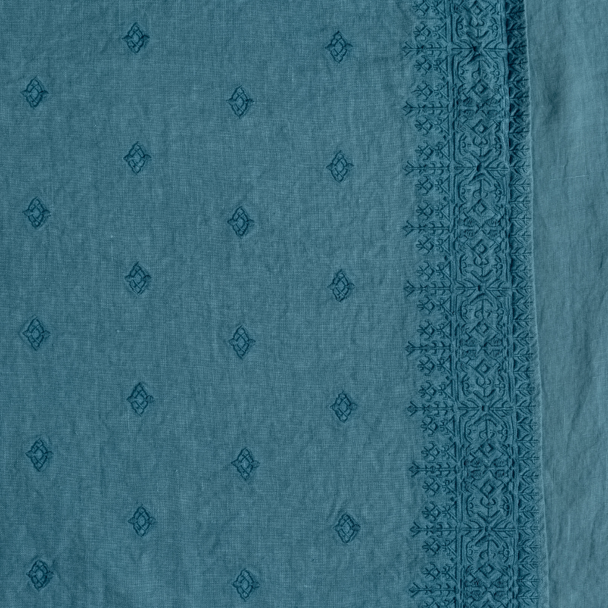 Ines Duvet Cover | Cenote | A close up of embroidered midweight linen fabric in cenote, a vibrant, ocean-inspired blue-green.