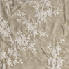 Lynette Yardage | Parchment | A close up of embroidered silk velvet fabric in parchment, a warm, antiqued cream.