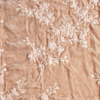 Lynette Yardage | Pearl | A close up of embroidered silk velvet fabric in pearl, a nude-like, soft rose pink tone.