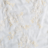 Lynette Yardage | White | A close up of embroidered silk velvet fabric in classic white.