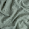 Midweight Linen Yardage | Eucalyptus | A close up of midweight linen fabric in eucalyptus, a soft light green.