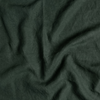 Midweight Linen Yardage | Juniper | A close up of midweight linen fabric in Juniper, a deep green tone.