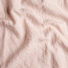 Midweight Linen Yardage | Pearl | A close up of midweight linen fabric in pearl, a nude-like, soft rose pink tone.