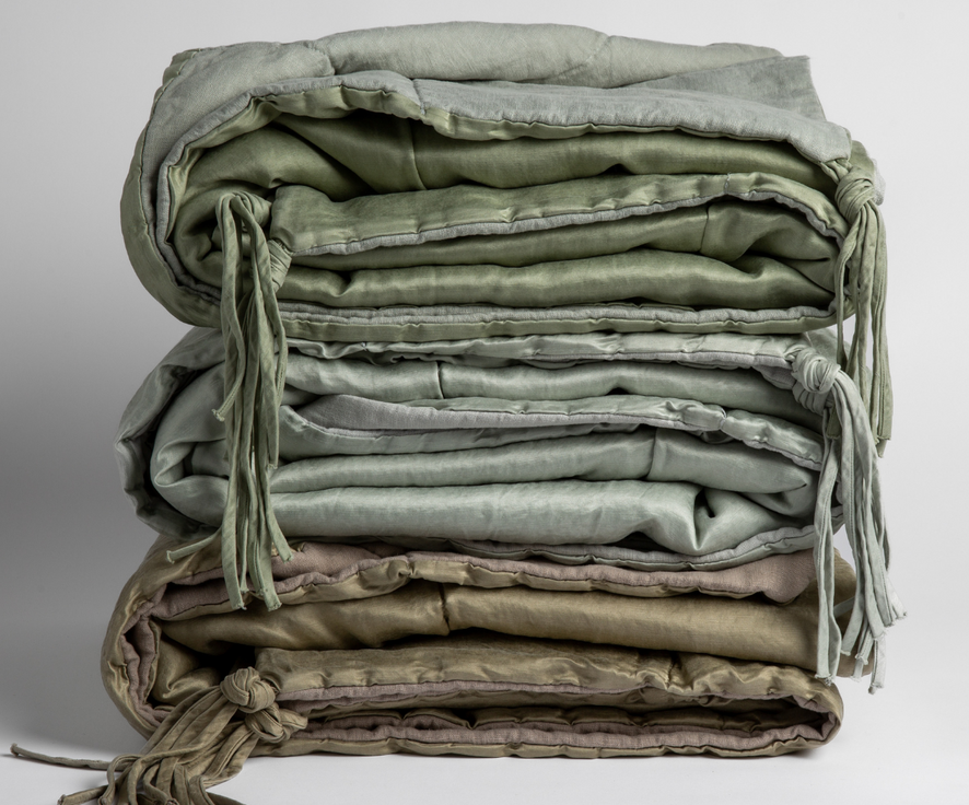 [allvariants]: stack of three blankets shows colors, textures and tassels. Blankets shown in Eucalyptus, Cloud and Fog against a white background